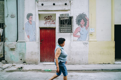 Full length of man standing against building