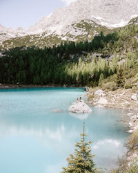 Scenic view of lake by mountain during winter