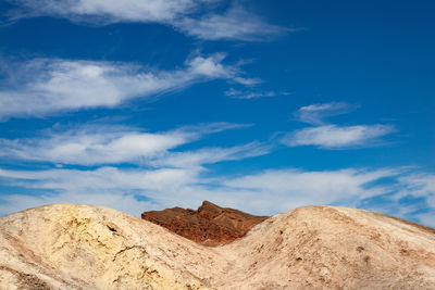 Scenic view of desert against blue sky