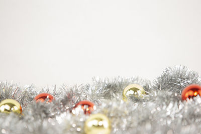 Close-up of christmas decorations over snow
