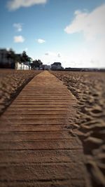 Surface level of footpath against sky