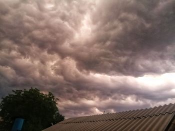 Low angle view of building against cloudy sky