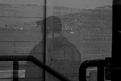 Shadow painting of man on wooden wall