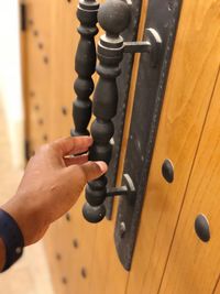 Close-up of man holding door handle