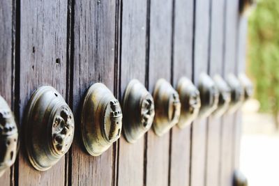 Close-up of objects on wooden fence