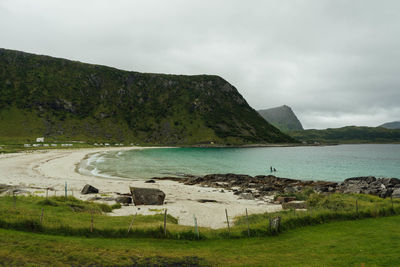 Scenic view of sea and mountains against sky