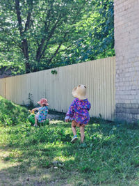 Rear view of woman standing on field