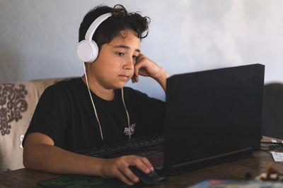 Boy doing his homework on laptop