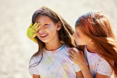 Cute girls playing with powder paint