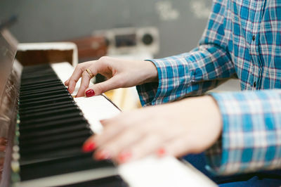 Close-up of hands playing piano