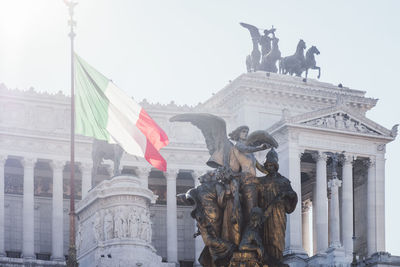 Low angle view of statue against historic building