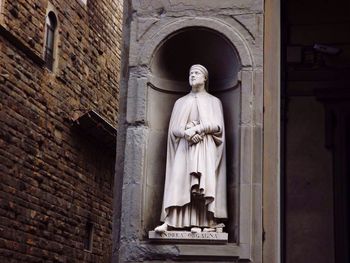 Low angle view of statue against building