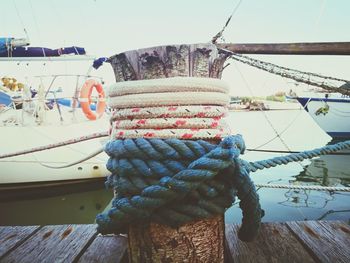 Close-up of fishing boat in sea against sky
