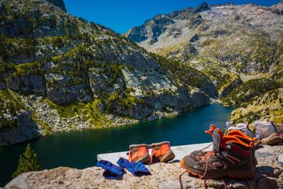 Hiking equipment on rock at lake