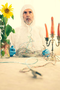 Man eating wires at table