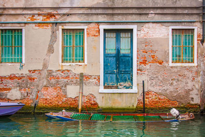 A wrecked boat into a canal water in venice, italy
