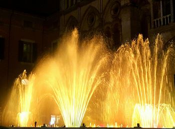 Illuminated ferris wheel at night
