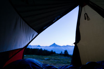 Tent against sky seen through window