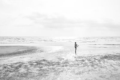 Full length of man on beach against sky