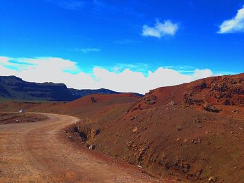 Scenic view of desert against blue sky