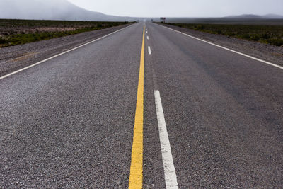 Empty road with highway in background