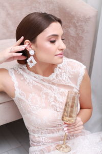 Midsection of bride holding bouquet