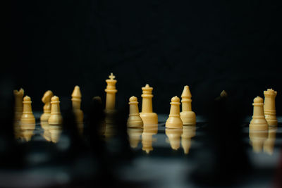 Close-up of chess pieces against black background