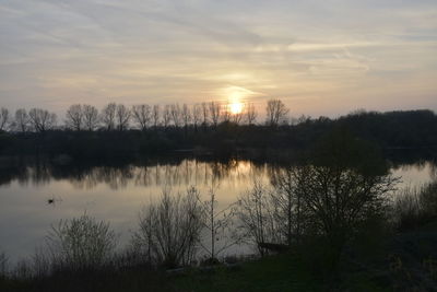 Scenic view of lake against sky during sunset