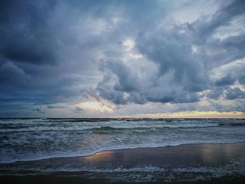 Scenic view of sea against cloudy sky