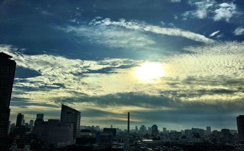 View of cityscape against cloudy sky