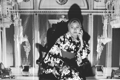 Woman wearing headscarf while standing indoors