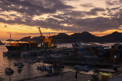 Harbor against sky during sunset