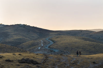 Scenic view of landscape against clear sky during sunset