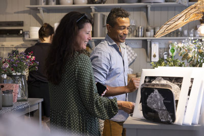 Smiling mature couple shopping together in store