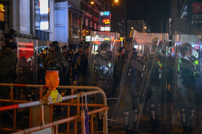 People standing on street in city at night