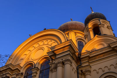 Low angle view of ornate building against clear blue sky