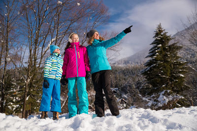 Family standing on snow covered land