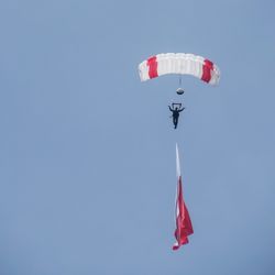 Man having fun paragliding mid-air