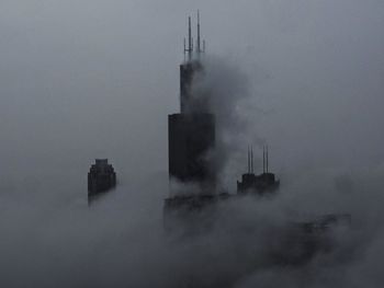 Smoke stack in factory against sky