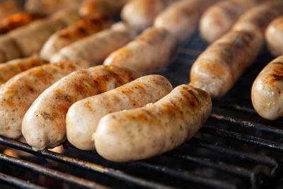 Grilled meat sausages on charcoal grill, outdoor picnic