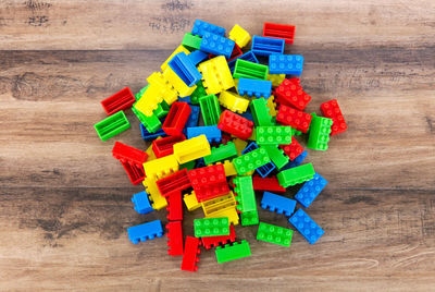 Directly above shot of multi colored toy blocks on hardwood floor