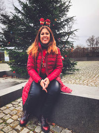 Portrait of smiling young woman sitting outdoors