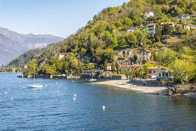 The colmegna coast in the lake maggiore with its beach and its villas