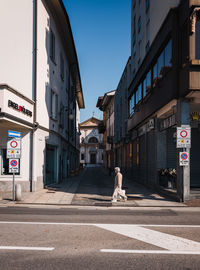 Street amidst buildings against sky