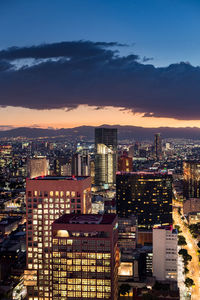 High angle view of illuminated buildings from mexico city during a summer sunset.