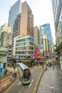 View of city street and buildings against sky