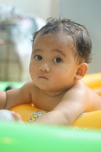 Baby boy swimming at home