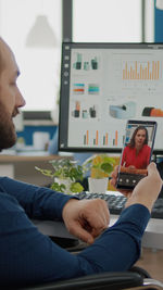 Side view of man using mobile phone