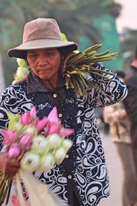 Woman holding bunch of flowers