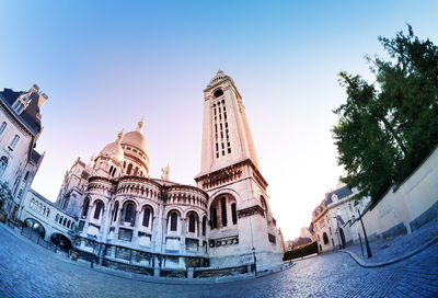 Low angle view of buildings in city against sky